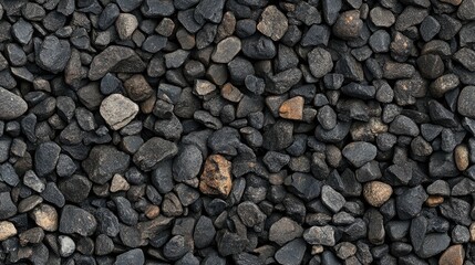 Small road stone backdrop featuring dark gravel pebbles with a textured surface Close up top view of gravel ideal for garden settings Patterns created by the gravel
