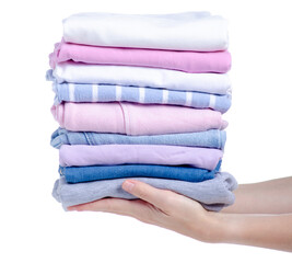 Stack of clothing jeans sweaters in hand on a white background isolation