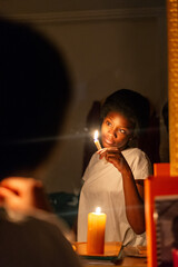 Keep Your Lamps Burning.A young woman holding a candle in the dark