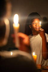 Keep Your Lamps Burning.A young woman holding a candle in the dark