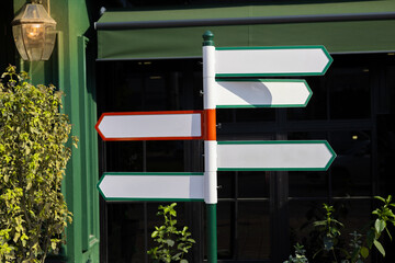 Colorful directional signpost in urban setting guides visitors to various locations
