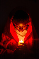 Keep Your Lamps Burning.A young woman holding a candle in the dark