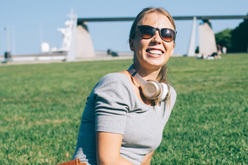 Fototapeta premium Charming modern woman on park meadow in sunlight