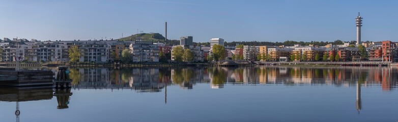 Panorama view, the district Hammarby sjöstad, boats, the district Södermalm, piers, boats, commuting ferries and apartment houses, a sunny summer day in Stockholm