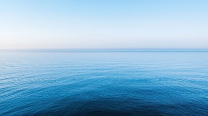 Obraz premium A serene view of calm ocean waters under a clear blue sky.