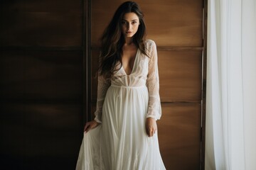 Fototapeta premium A boho-chic long-sleeve white wedding dress with intricate lace embroidery and flowing chiffon accents