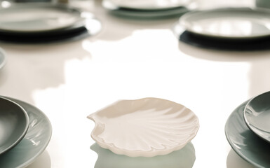 Fototapeta premium Several ceramic plates on a table in a restaurant, macro.