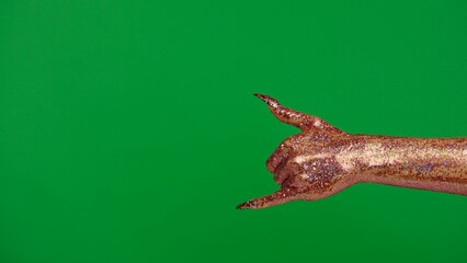 Creepy halloween monster hand in glitter slime with nails shows shaka loose sign, isolated on chroma key green screen background, workspace mockup.