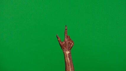 Creepy halloween monster hand in glitter slime with nails pointing finger up, isolated on chroma key green screen background, workspace mockup.