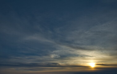 Russia, south of Western Siberia. Panoramic view of the evening sky with the setting sun and colorful clouds.
