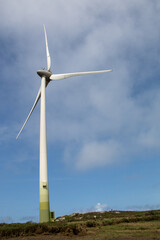 Windmills producing electricity at full capacity with the ocean in the background on La Costa Da Morte in Galicia