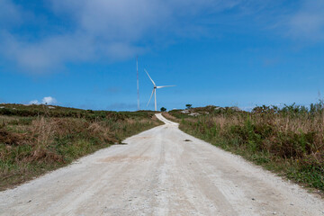 Windmills producing electricity at full capacity with the ocean in the background on La Costa Da Morte in Galicia