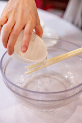 Washing chopsticks and bowls with tea at a Cantonese restaurant, highlighting traditional dining customs for hygiene and respect