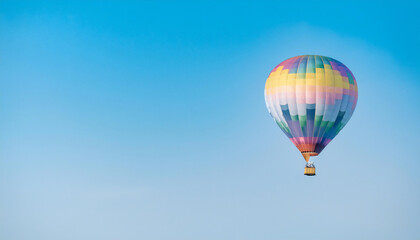 Naklejka premium Hot air balloon flying against the sky. Hot air balloons are aircraft that gain their weight by heating a large envelope of air above ambient temperature.