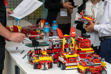 The competition judge checks the condition of the robots

