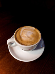cup of coffee on table and black background