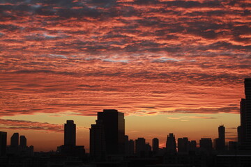 Sunrise Cityscape: A breathtaking panorama of a city skyline, silhouetted against a vibrant red and orange sunrise, evokes a sense of wonder and tranquility.  