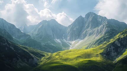 Fototapeta premium Stunning mountain landscape with lush green valleys and towering peaks under a partly cloudy sky.