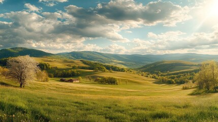Obraz premium A serene landscape featuring rolling green hills under a vibrant sky with fluffy clouds, evoking tranquility and natural beauty.