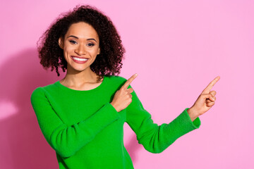 Photo of charming cheerful cute woman wear green stylish clothes demonstrate banner empty space isolated on pink color background