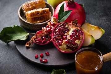 Rosh Hashana concept with honey, apple and pomegranate
