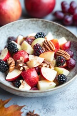 fall fruit salad featuring diced apples, red grapes, blackberries, and crunchy pecans, lightly...