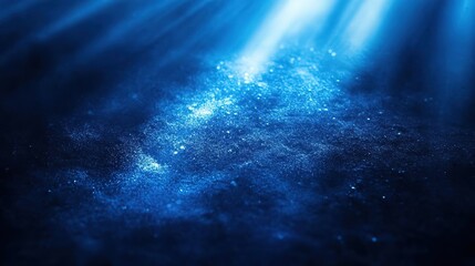 A serene underwater scene illuminated by beams of light, showcasing the beauty of deep blue water and floating particles.