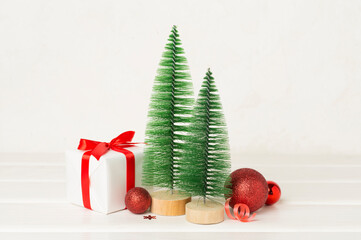 Small christmas trees with decoration on wooden table