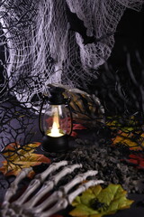 Halloween. Creepy screensaver. Decor for the holiday Halloween. Bony hands on the ground among the black branches