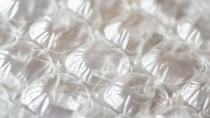 Close-up of bubble wrap texture, perfect for packaging, shipping, and protection-related designs.