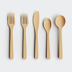 Set of wooden utensils including fork, knife, and spoon, isolated on a white background.