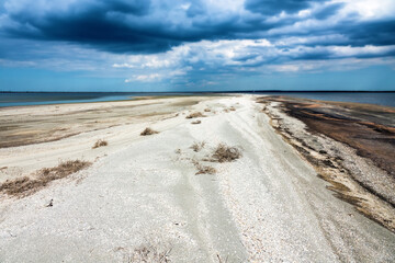 A bay bar, sand-shell spit in a shallow southern lagoon, onshore motion of sediments (cardium...