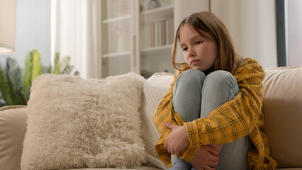 Unhappy stressful depressed caucasian girl schoolgirl sad alone at home thinking psychological...