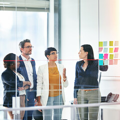 Business people, presentation and glass wall for collaboration, brainstorming and teamwork in...