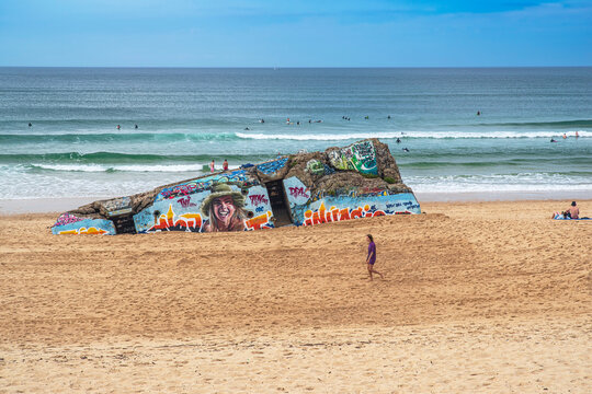 Capbreton,Nouvelle-Aquitaine / France- 09/03/2023: Painted bunker and walker on the beach at Capbreton in the Landes region of France