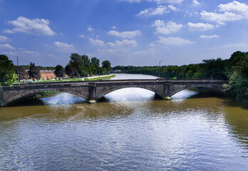 Naklejka premium low level aerial view of the old stone arched bridge over the River Ribble on Liverpool Road into Preston City Centre, Lancashire, England 
