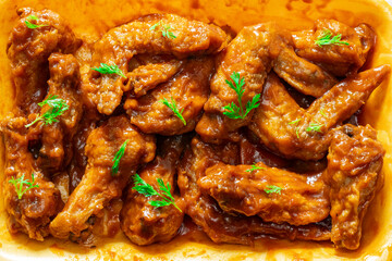chicken wings smothered in hot sauce, close-up view