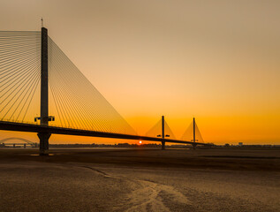 Obraz premium Liverpool, Merseyside, UK, September 18, 2024; aerial view of the Mersey Gateway toll bridge with stunning sun set over the River Mersey, Liverpool, UK.