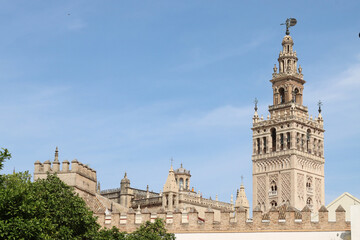 The giralda, bell tower of seville cathedral standing tall under blue sky