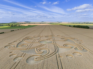 Aerial view of an intricate geometric crop circle formation in a wheat field near Etchilhampton and...