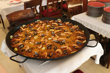 Large paella pan resting on table in restaurant