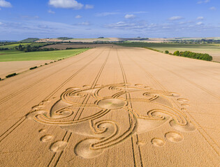 Aerial view of an intricate geometric crop circle formation in a wheat field near Etchilhampton and Devizes in Wiltshire, England, UK