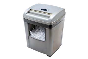 Silver paper shredder with full bin of shredded paper on transparent background