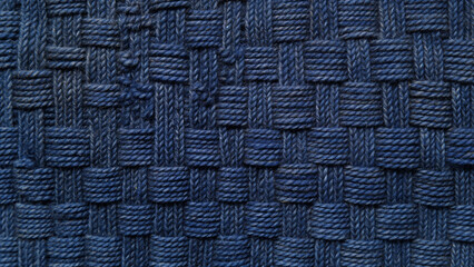 Close-up of a blue woven textile pattern, perfect for fabric, texture, and craft-related designs.