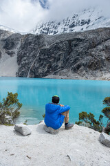 Child looking out over a lake of intense turquoise colours