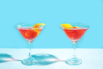Pink martini cocktail with lemon twist