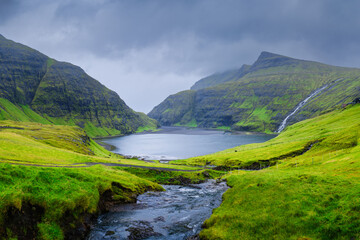 Saksun village, Streymoy Island, Faroe Islands, Denmark. Panoramic view of the pasture and the mountains. Photography for background, wallpaper, postcards.