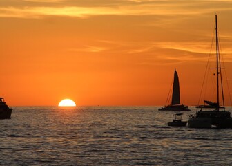 An enchanting sunset in Key West, where the sun sinks behind the horizon, painting the entire sky...