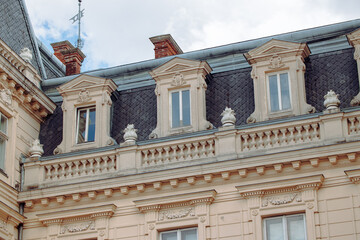 Ukrainian renaissance architecture cultural heritage site touristic destination place sightseeing from foreshortening from below exterior facade of windows roof and pillars