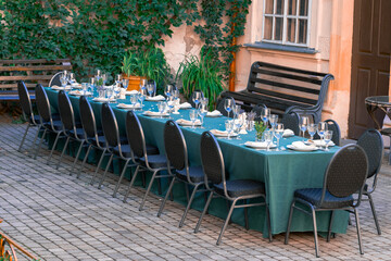 served by dishes cutlery table in street cozy yard summer urban cafe patio place without people here